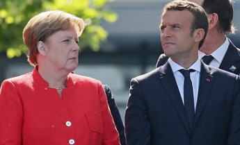 Меркель и Макрон договорились продвинуть вперед минский процесс